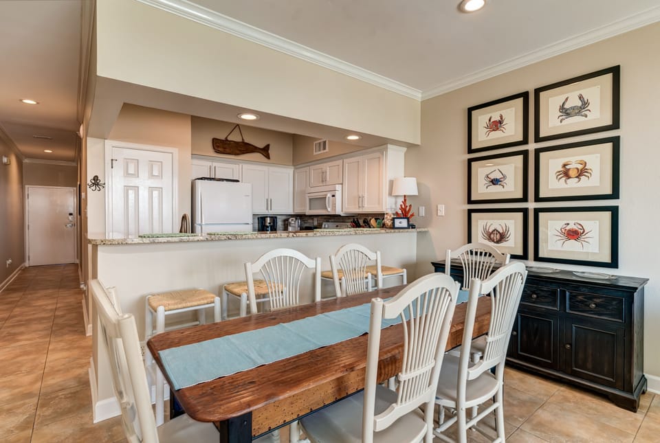 The dining area provides space for 6 at the table and 4 at the bar area
