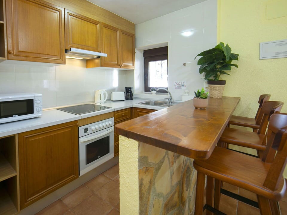 Furniture, Countertop, Kitchen, Flooring, Interior Design, Cabinetry, Wood, Kitchen Appliance, Floor, Major Appliance