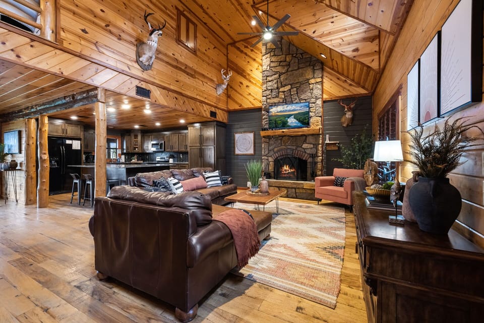 Expansive beautifully decorated Living Room w/ Real Rock Fireplace open concept