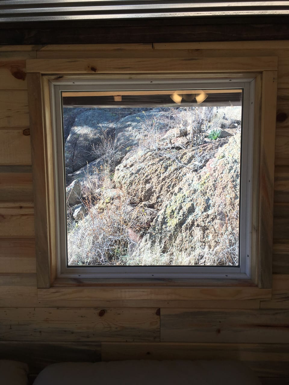 picture window looking out to rock wall