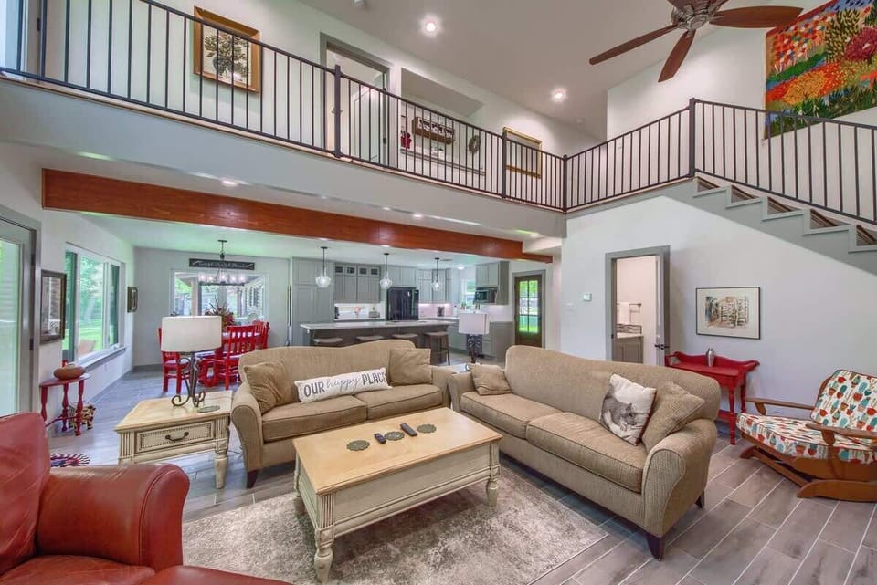 Beautiful view of the kitchen and living area with a sneak peak of the upstairs walkway. 