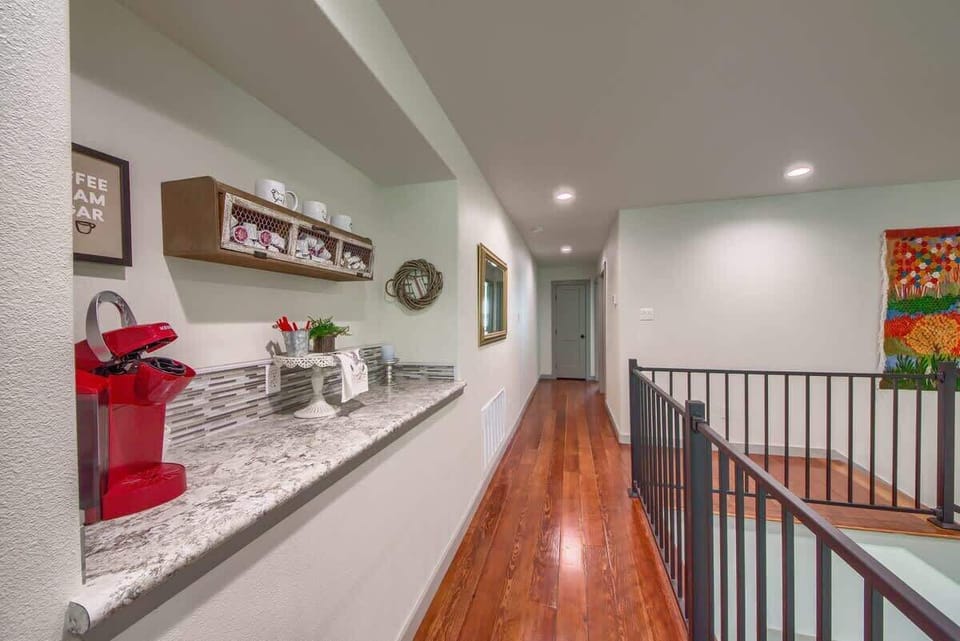 Gorgeous hardwood floors in the upstairs walkway with a convenient keurig coffee bar. 