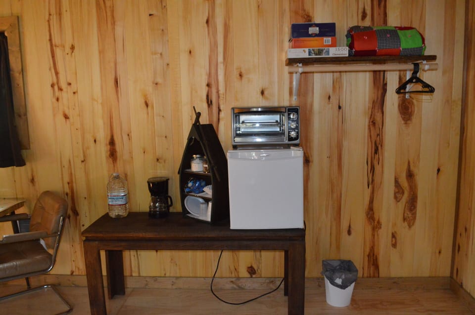 There is a small fridge and an oven toaster. Some games and puzzles too.