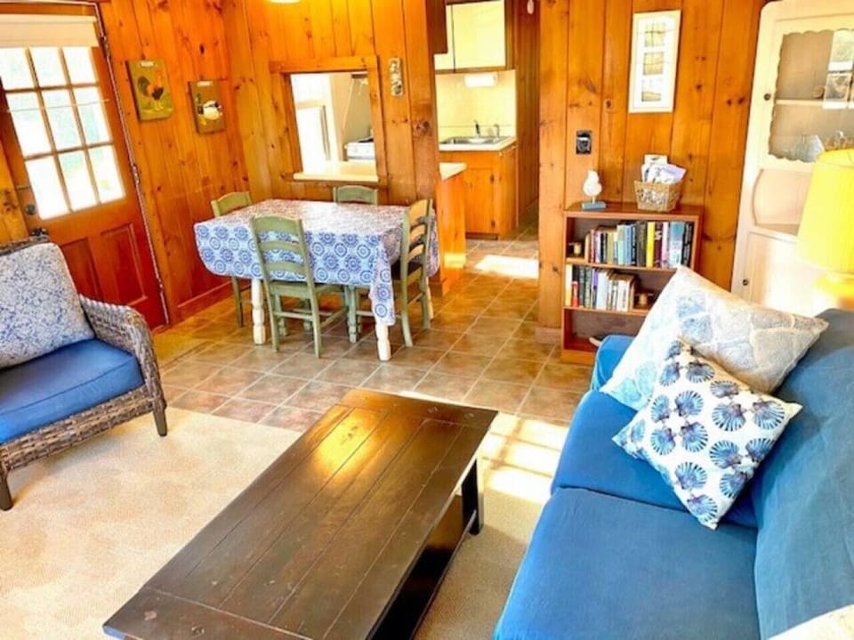 Dune Suite living room with view to dining area and fully-equipped kitchen.