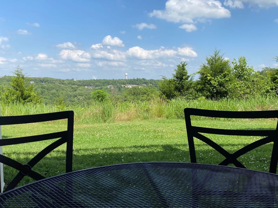 Peaceful outdoor patio with an Ozark mountain view of the Branson Strip