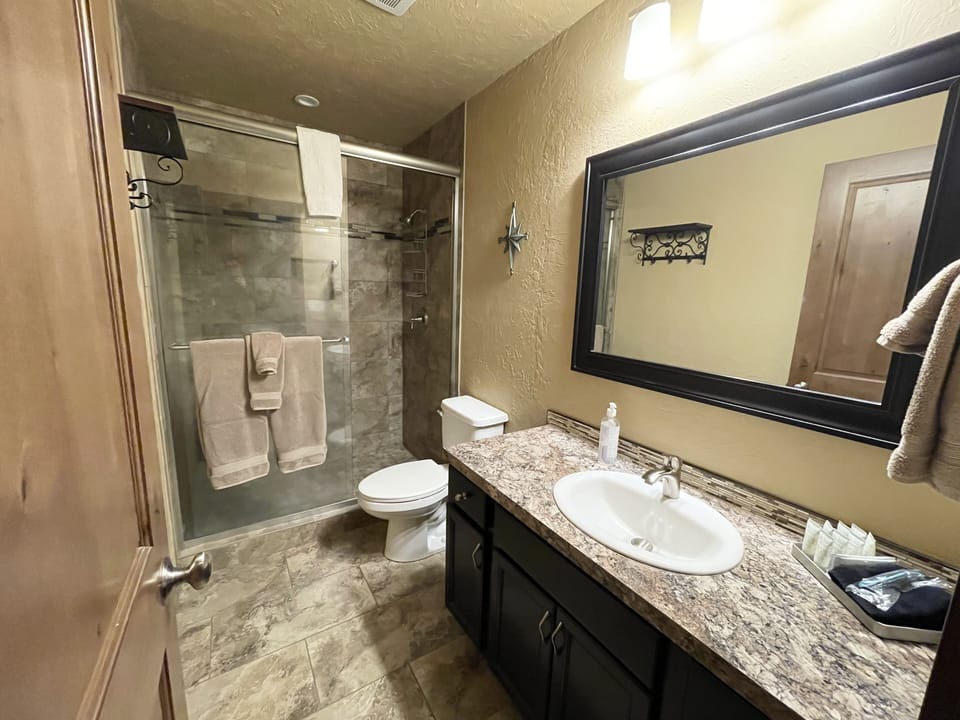 Downstairs bath. Tile and low step shower entry.