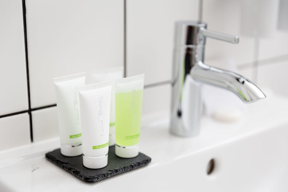 Shower, designer toiletries, hair dryer, bathrobes