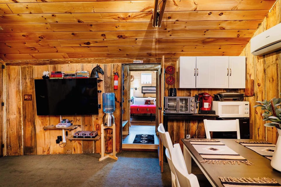 [Barn Loft, Upstairs] The primary bedroom is secluded via a railroad-style hallway... let's enter!