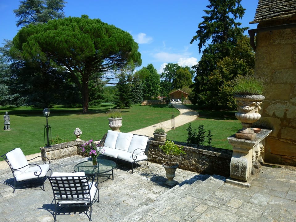 Extensive terrace with outdoor dining and casual seating area.