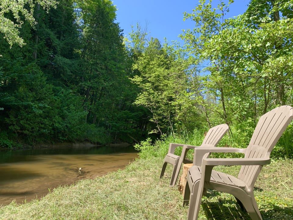 Ready to relax?  Walk right in!  600’ of river frontage on 8+ beautiful acres. 