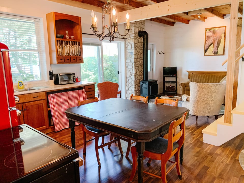 Between sitting area and eat-in kitchen, sliding glass doors to water and view.