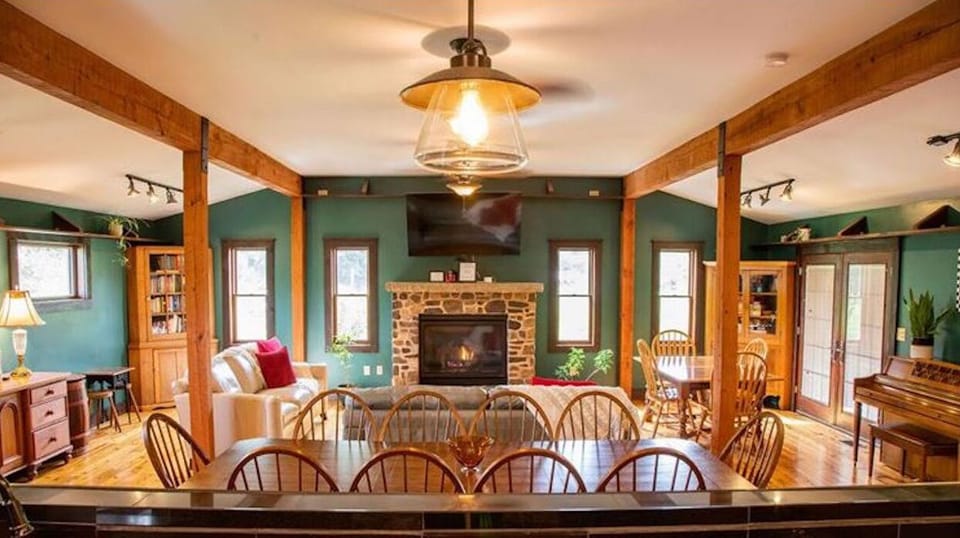 Great room w/ kitchen, dining room w/ seating for 14, living room & large deck.