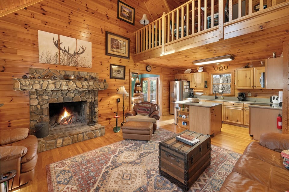 Cozy up in this rustic cabin with crackling stone fireplace and open kitchen—your perfect mountain retreat awaits.