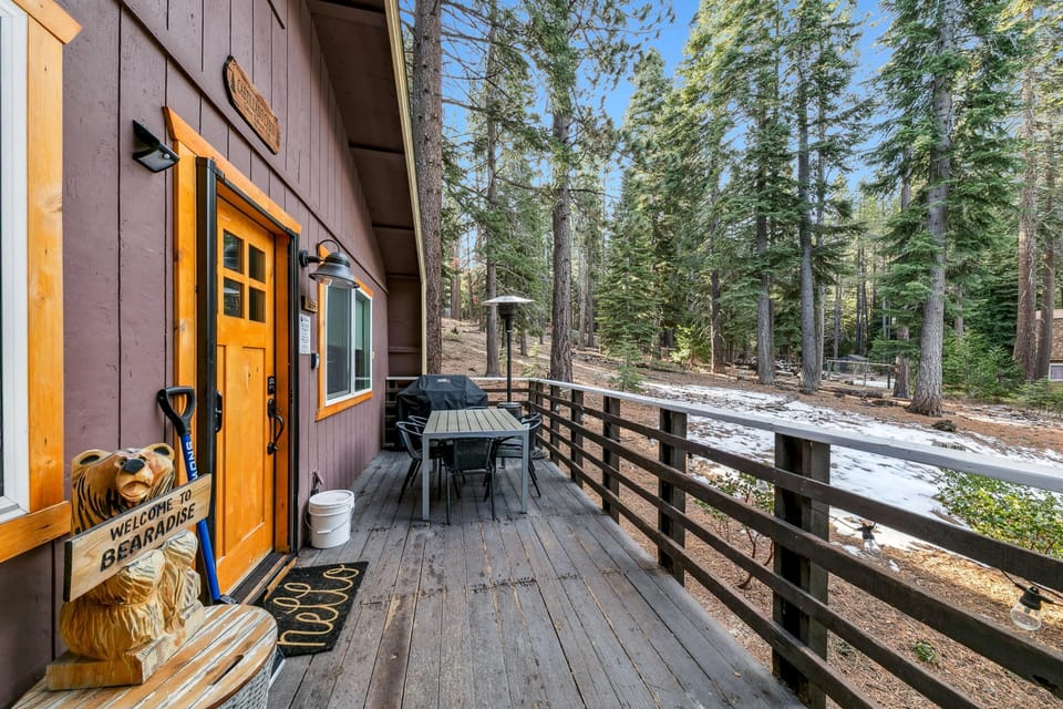Spacious outdoor deck with forest views and cozy seating