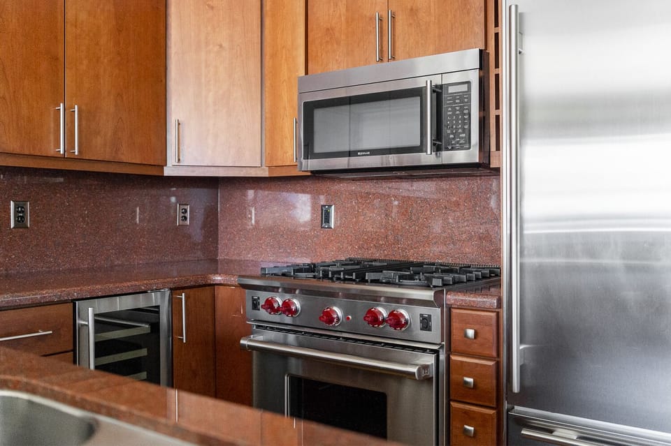 Stainless steel appliances in the kitchen, Wolf gas range and over the range microwave
