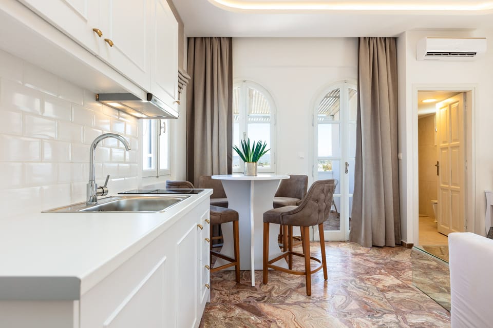 Junior Suite, Sea View | Private kitchenette | Mini-fridge, electric kettle, cookware/dishes/utensils, dining tables