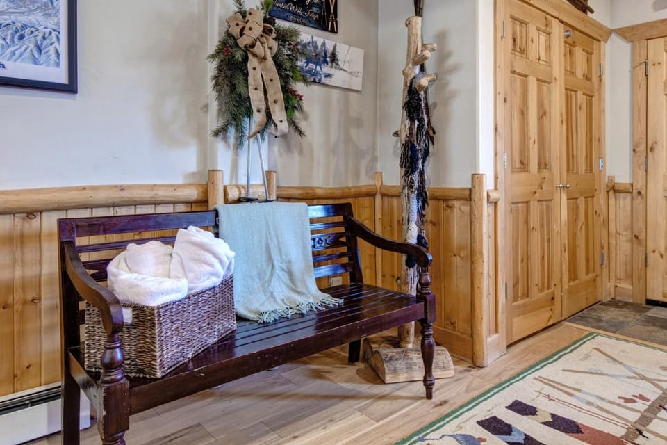 Cozy lodge entryway with rustic bench and warm winter charm.