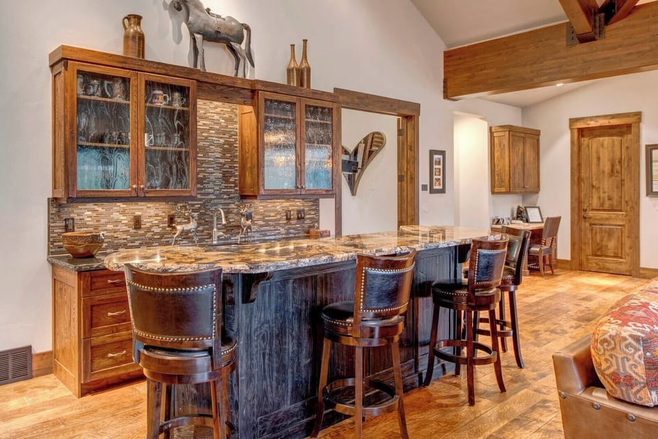 Gather for appetizers or cocktails at the kitchen bar with seating and stylish lighting.
