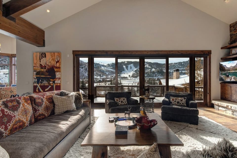Slide open the glass doors and gather in the main living area, where indoor comfort meets fresh mountain air.