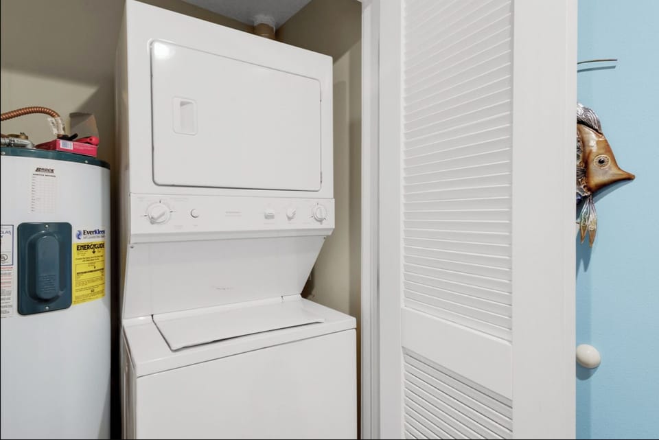 Your in-unit washer and dryer stack makes staying fresh effortless, tucked neatly in this convenient laundry closet.