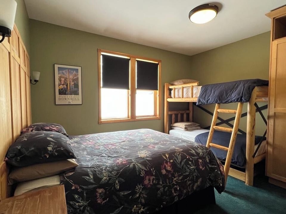 Middle level bedroom with queen bed and bunk beds.