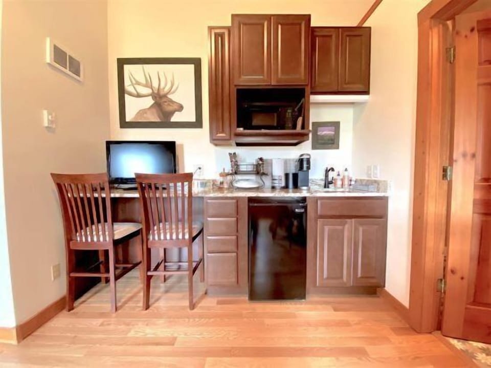 Kitchenette area with mini-fridge, toaster oven, microwave and Keurig coffee maker.