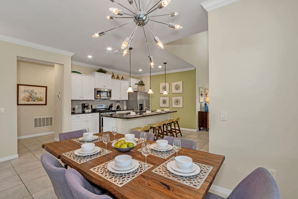 Alluring dining area of the home in Davenport Florida - 6 Persons dining - Chic dining area featuring a stylish table and contemporary seating - Open layout seamlessly connecting the dining area to the kitchen