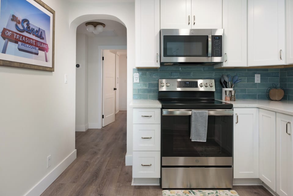 Chef's kitchen featuring an electric range, stove, and microwave.