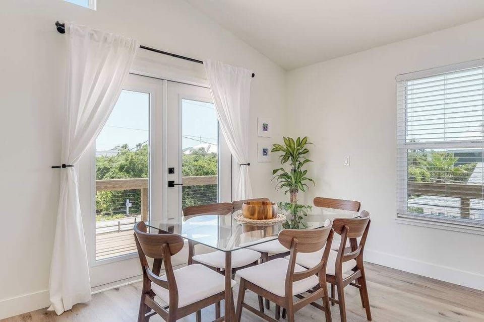 Bright, airy living space with cozy seating, modern kitchen, and beachy charm—perfect for relaxing after a day by the shore.