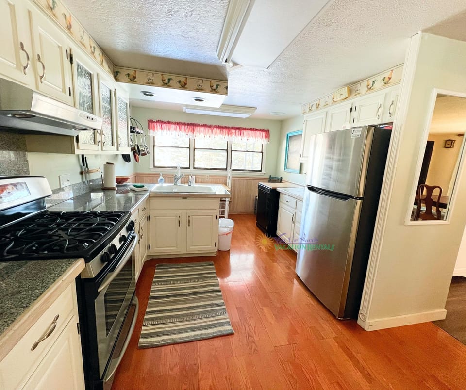 Full size kitchen with breakfast table. - Fully equipped, cooking basics, dishware & flatware, microwave, toaster, drip coffee maker, Keurig coffee maker, dishwasher, trash bags, paper towels.