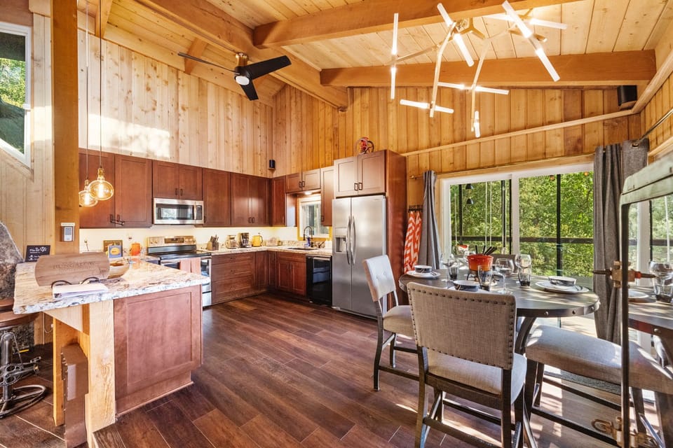 The kitchen is fully equipped and features both a dining table - The kitchen is fully equipped and features both a dining table and a breakfast bar for additional seating.