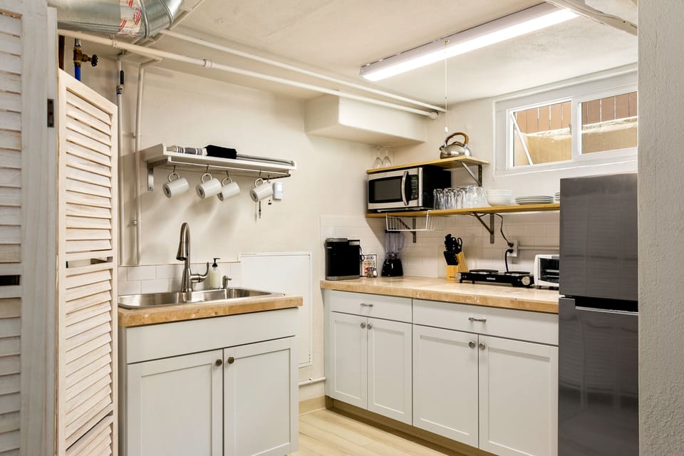 Super cute and cozy mini kitchen with everything you need to cook meals and save on eating out.