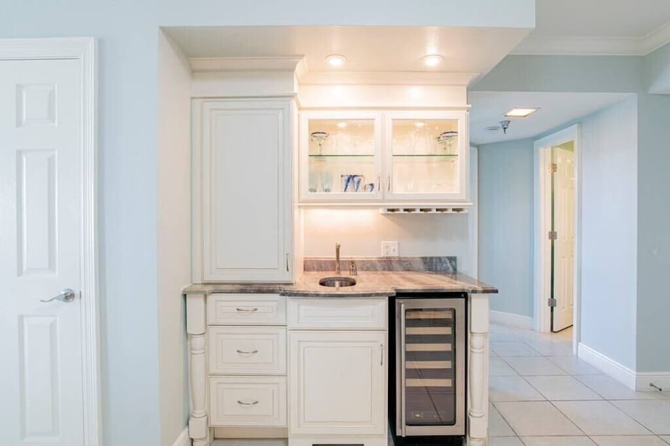 Separate beverage bar with wine cooler.