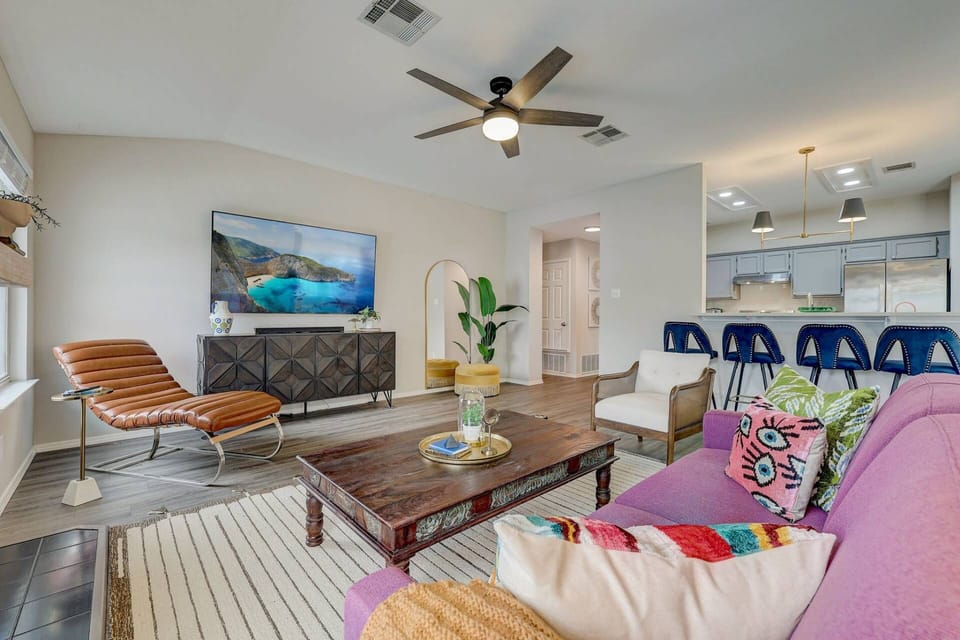 Living room with TV and seating at the kitchen countertop