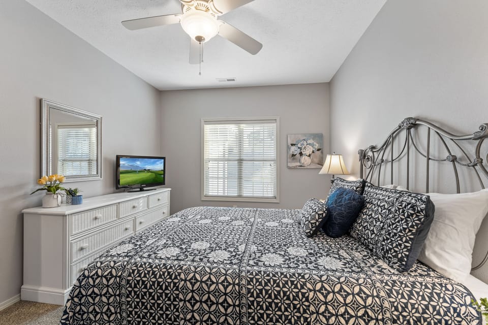 Downstairs guest bedroom with a queen bed