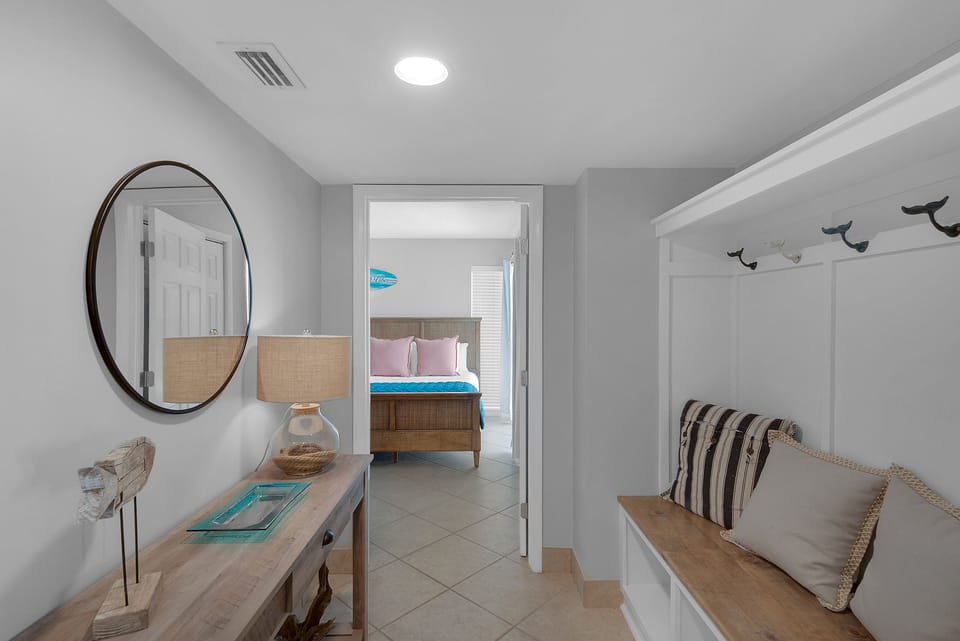 Entry with seating beach and entry to guest room.