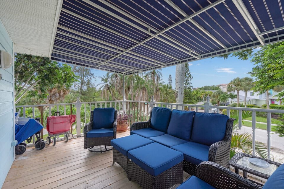 Sarasota, Florida retreat featuring a relaxing covered balcony with comfortable seating and tropical views—perfect for morning coffee, evening cocktails, and effortless outdoor living.