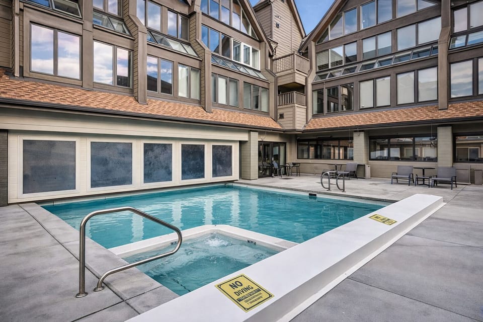 Dive into relaxation at this pristine courtyard pool, surrounded by modern architecture and comfortable seating areas for your perfect retreat.