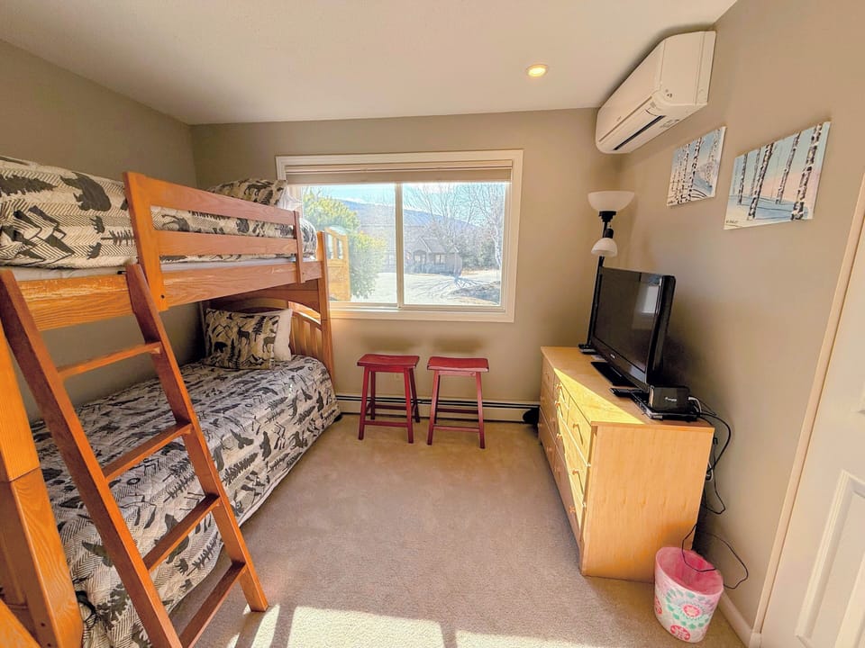 Bunk Bedroom with Two Twin over Twin Bunk Beds, TV, and Air Conditioning