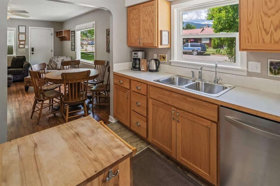 Cozy dining area beside the kitchen with a round table for six and a convenient coffee maker nearby.