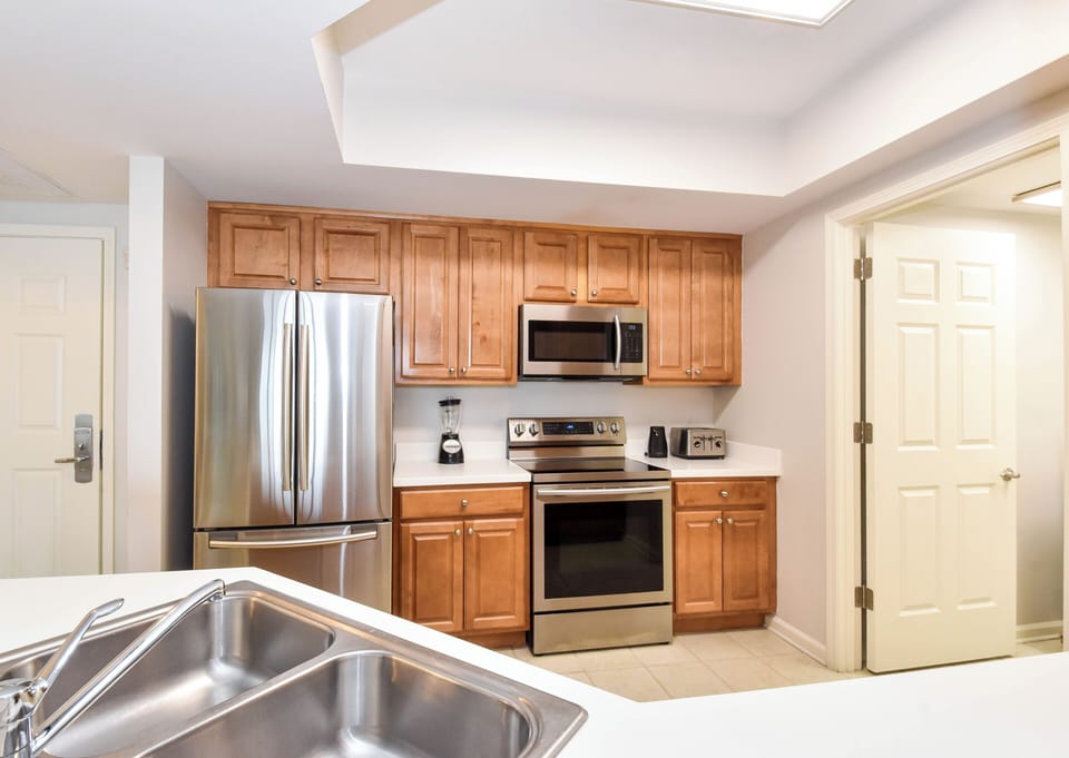 Your fully-equipped kitchen features warm wood cabinetry, stainless steel appliances, and everything you need to prepare delicious meals during your stay.