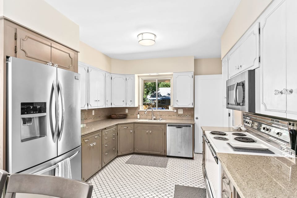 Stunning large and functional kitchen on main level mixing old world charm with modern convenience featuring tile floors and upgraded appliances.