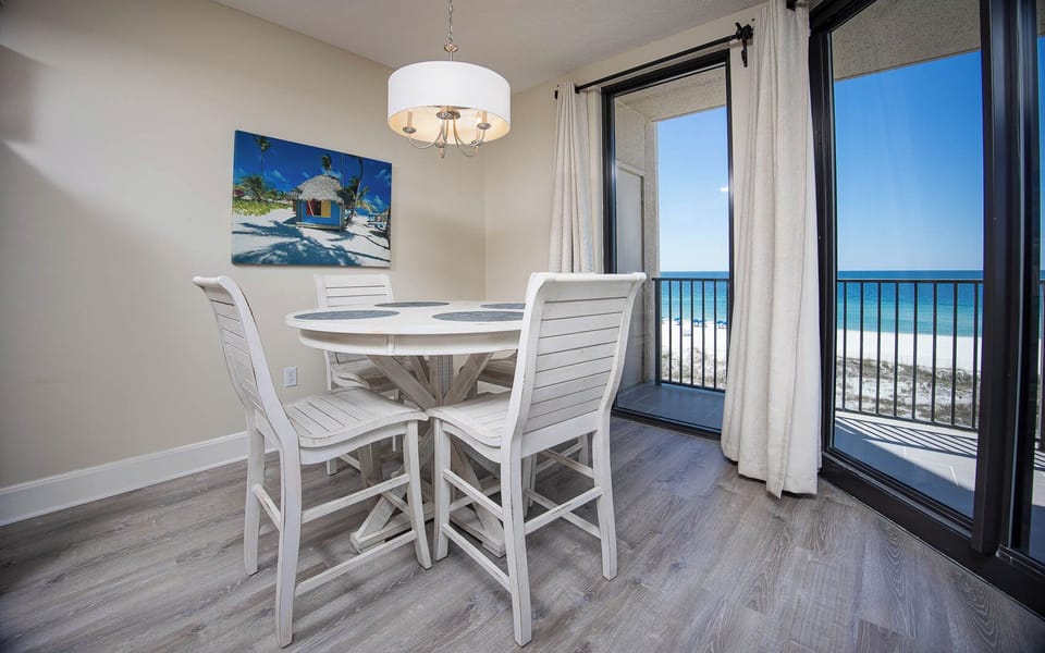 Dine at the round table while enjoying views through large glass doors that open to the beautiful coastline