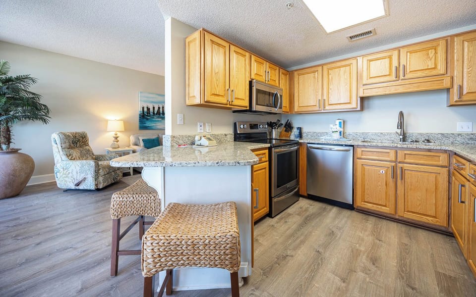Cook and gather in the inviting kitchen with stainless appliances, granite countertops, and seating at the breakfast bar