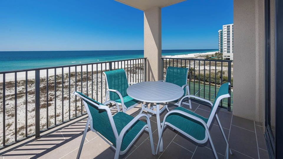 Relax on the balcony with comfortable seating and enjoy the expansive views of the coastline and tranquil waters