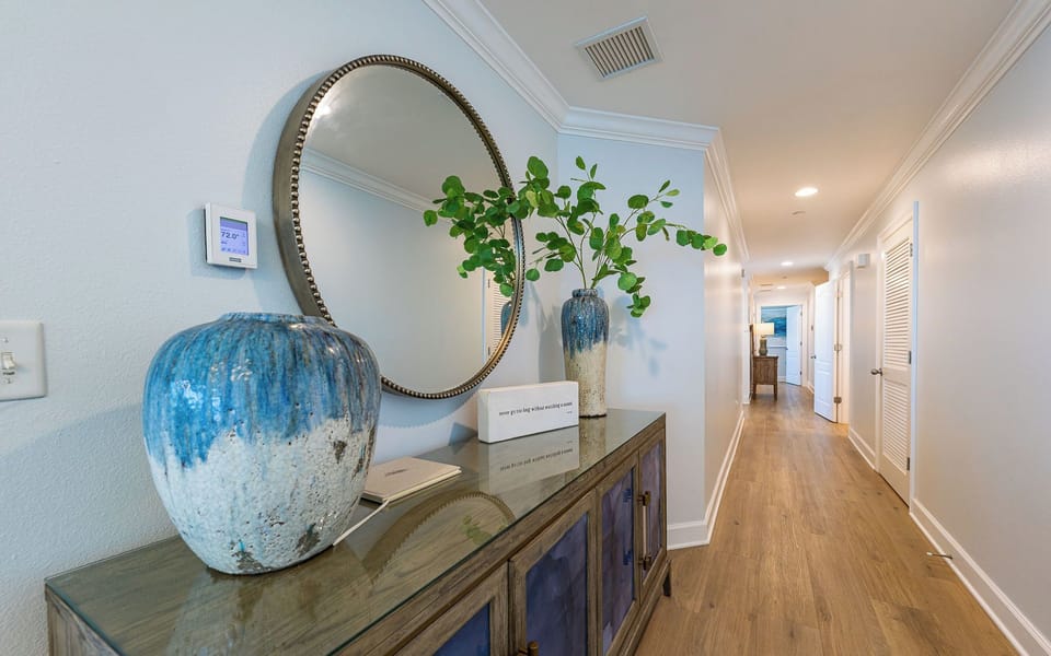 Step into a welcoming hallway adorned with tasteful decor, setting the perfect tone for your coastal getaway