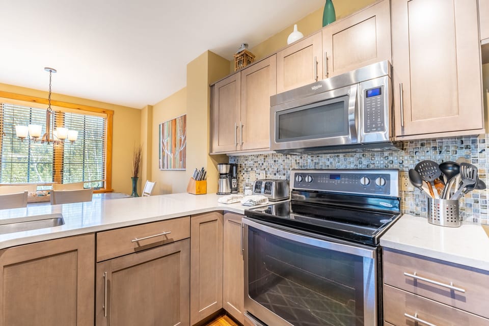 Cook memorable meals in your fully equipped kitchen with stainless steel appliances and bright natural light streaming in.