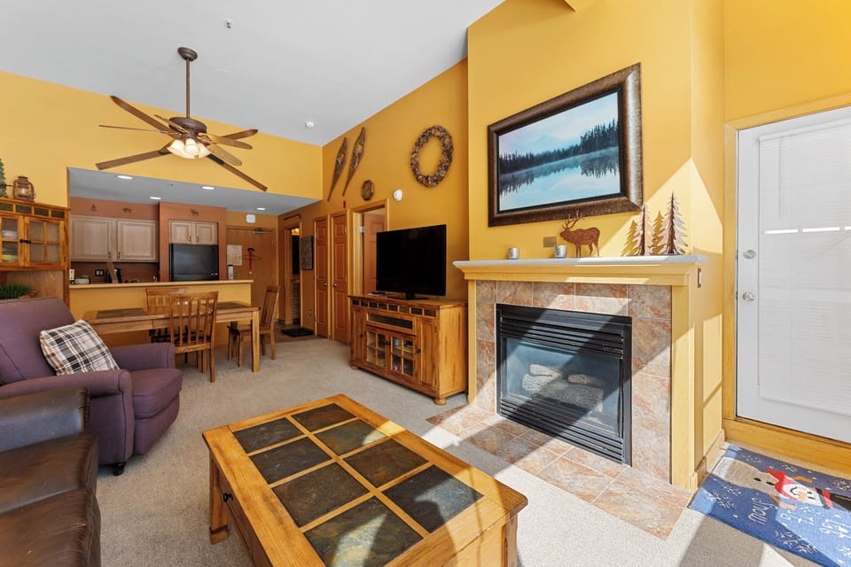 Cozy up by your stone fireplace while enjoying mountain views and rustic charm in this inviting retreat.