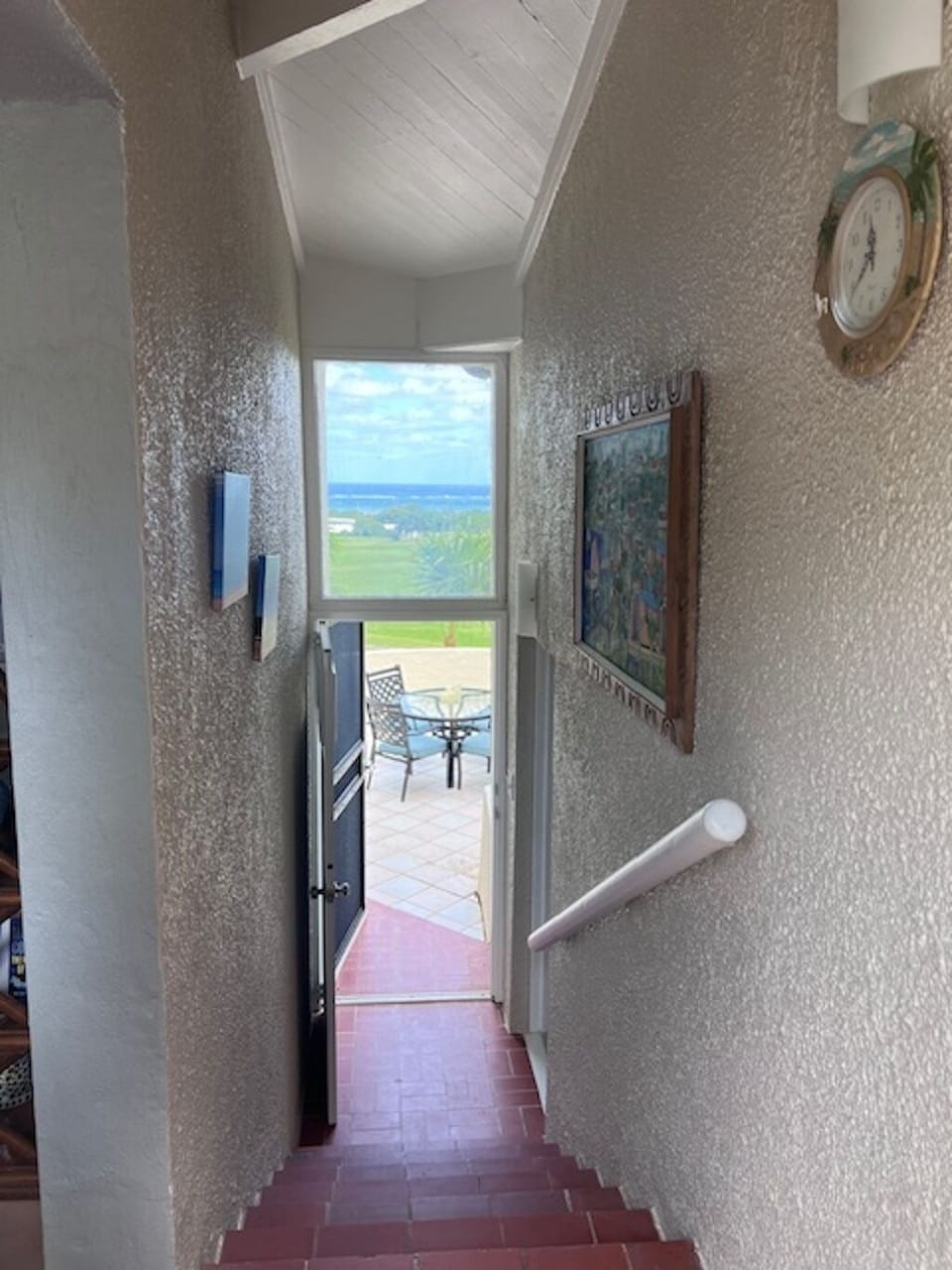 Stairwell to back patio overlooking ocean, Buck Island and golf course.