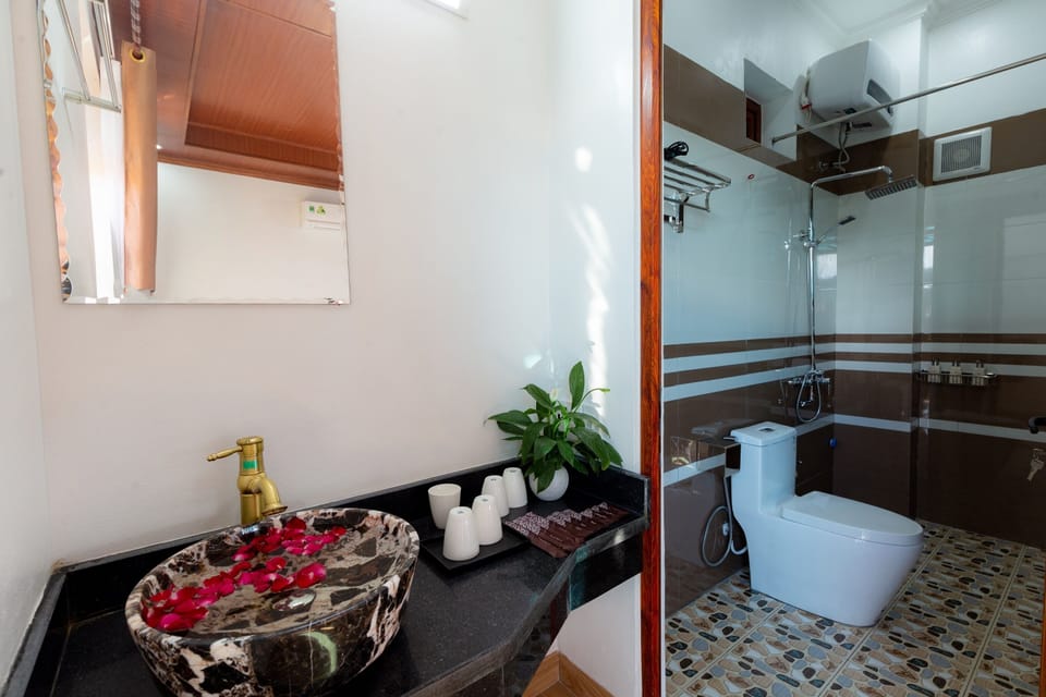 Shower, hair dryer, slippers, towels